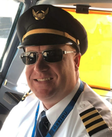 Photo of a professional pilot wearing a pair of Scheyden Mustang Sunglasses