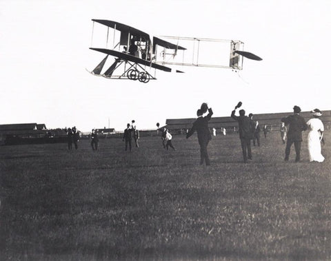 A photograph of the Rodgers Wright EX biplane dubbed "Win Fiz" in flight.