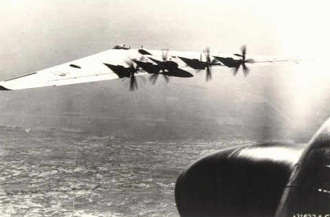 A photograph of the XB-35 in flight taken by a P-61 fighter aircraft.