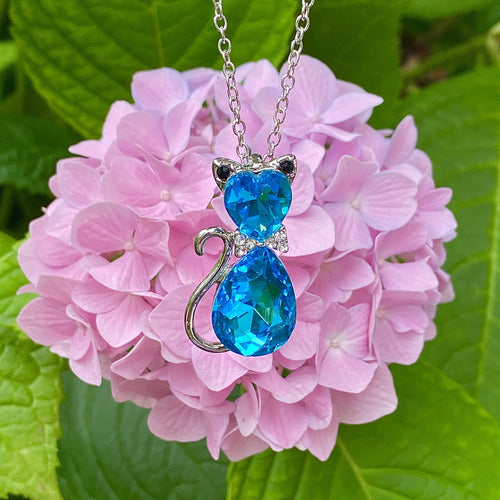 Pendant with blue gemstone near crystal piece · Free Stock Photo
