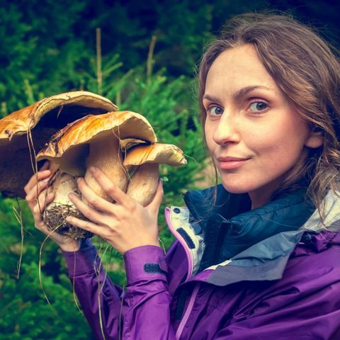 Woman holding reishi mushrooms in HEAR ME RAW Good Clean Fungi Cleansing Bal