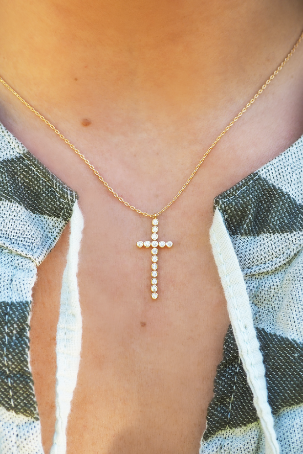 Beads of pearls and a cross necklace on lace. - GoodSalt