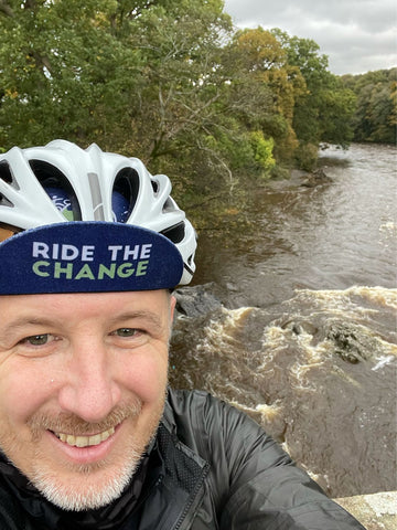 Ben Smith in a cycling helmet taking a selfie