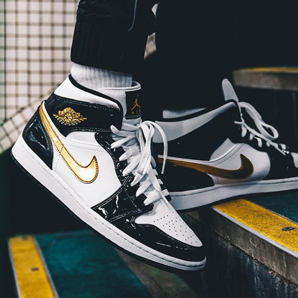 gold and black jordan 1 mid