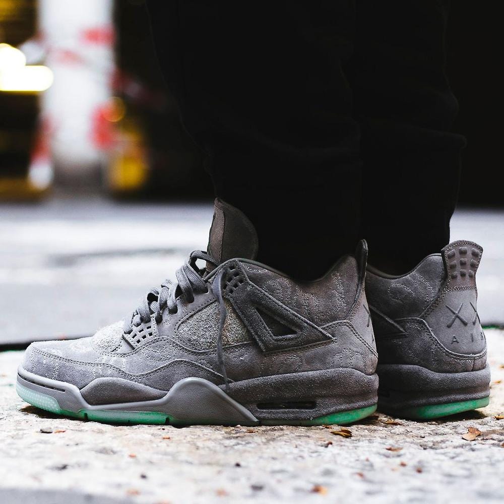 grey jordan 4 kaws