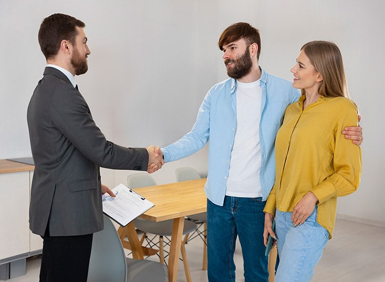 A regular customer and a Turmerry mattress store worker shaking hands
