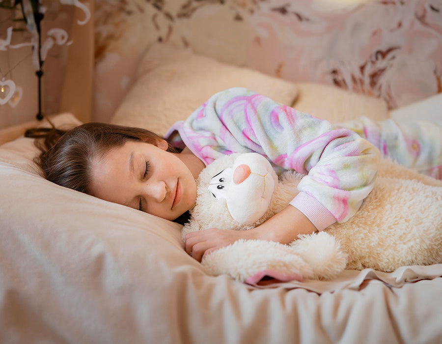A young child sleeping peacefully in a cozy bed, emphasizing the importance of restful sleep for children's health and development.