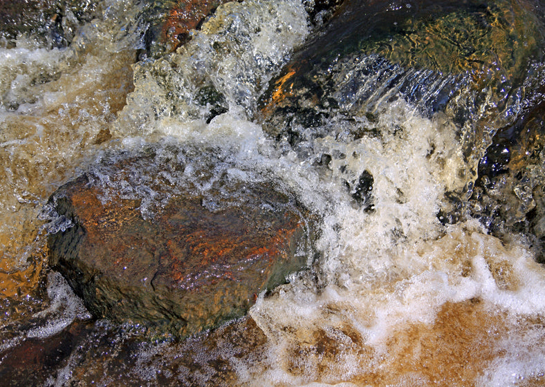 quick river flow amongst stone