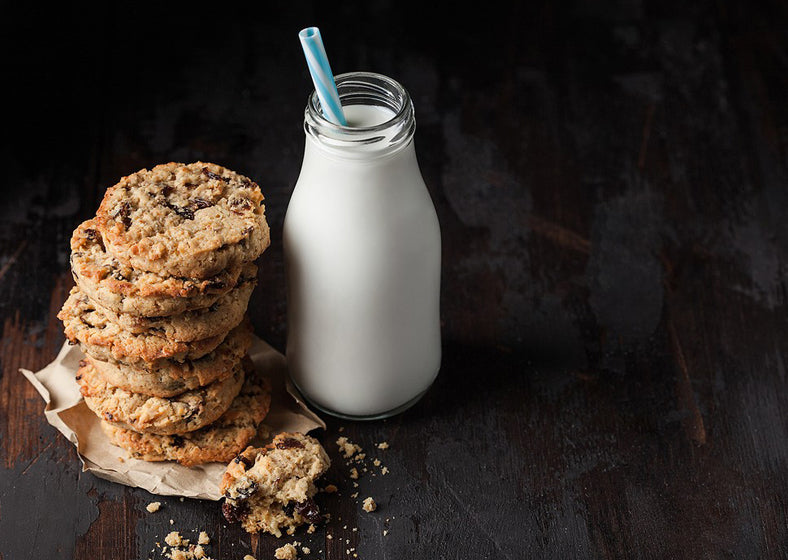 homemade organic oatmeal cookies with raisins and apricots and bottle of milk