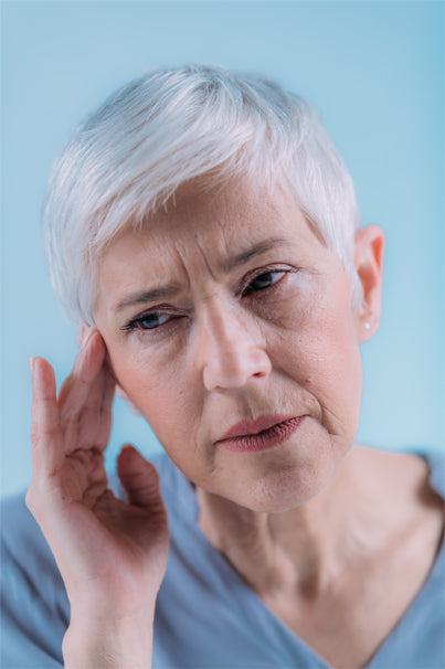 a senior woman suffering from Tinnitus.