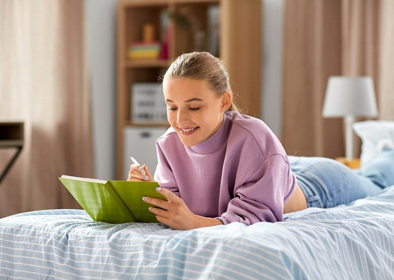 a teen writing journal on a twin xl bed