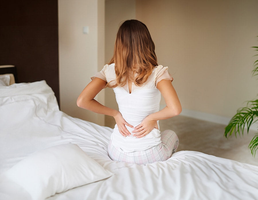 a woman struggling with back pain