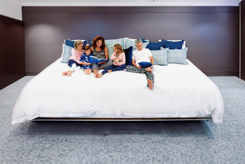 sleeping families on the largest oversized mattress - Alaskan king