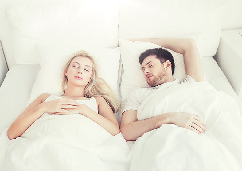 couple sleeping on a queen mattress