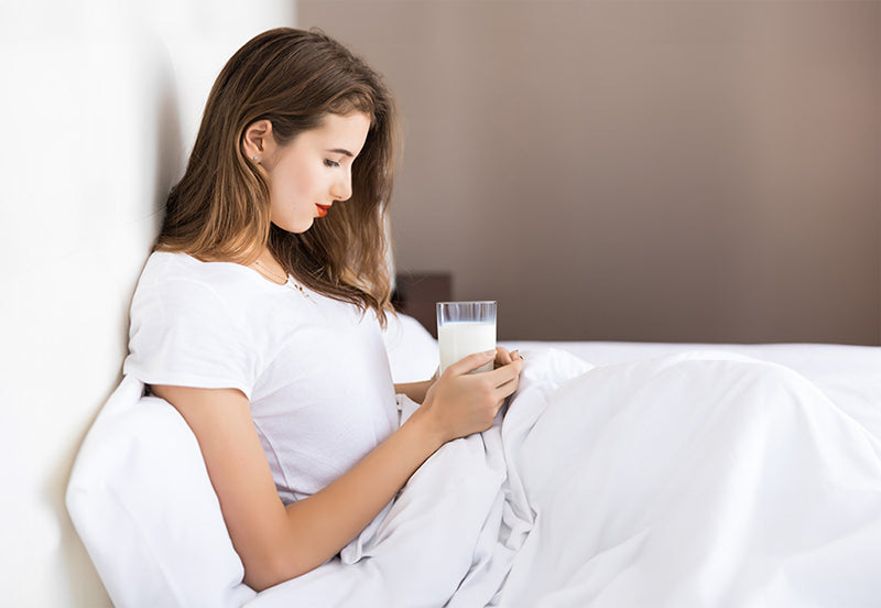 drinks that help you sleep at night - a women drinking warm milk for quality sleep