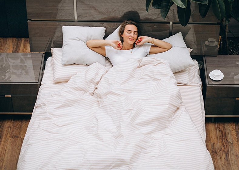 a woman sleeping on a comfortable mattress