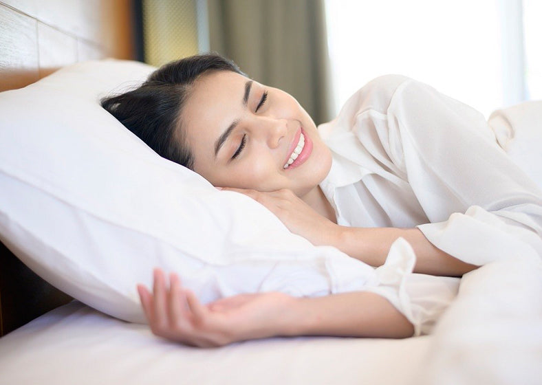 woman sleeping comfortably on a split king bed