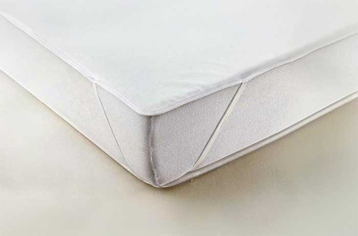 Securing soft crib mattress pads/protectors to crib mattress with elastic