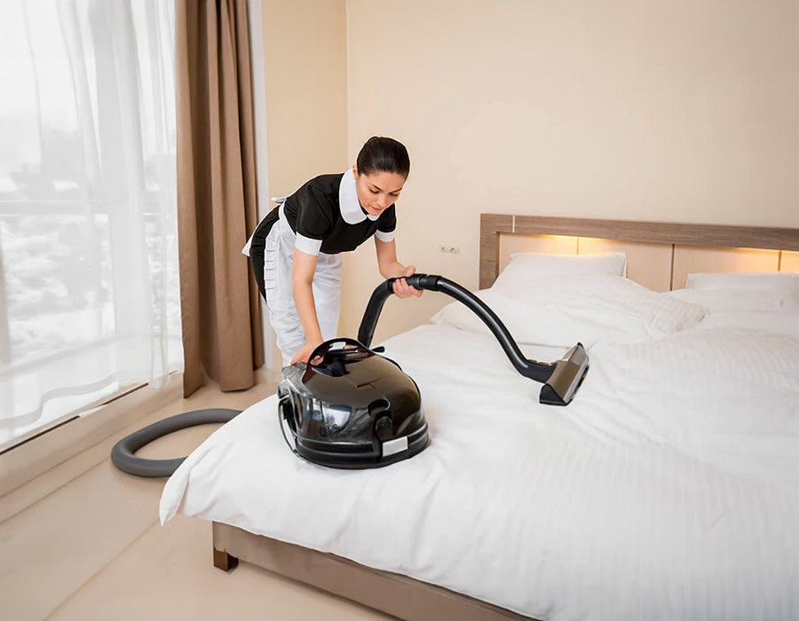 Person vacuuming a topper