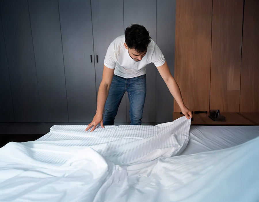 Putting a fitted sheet over bed