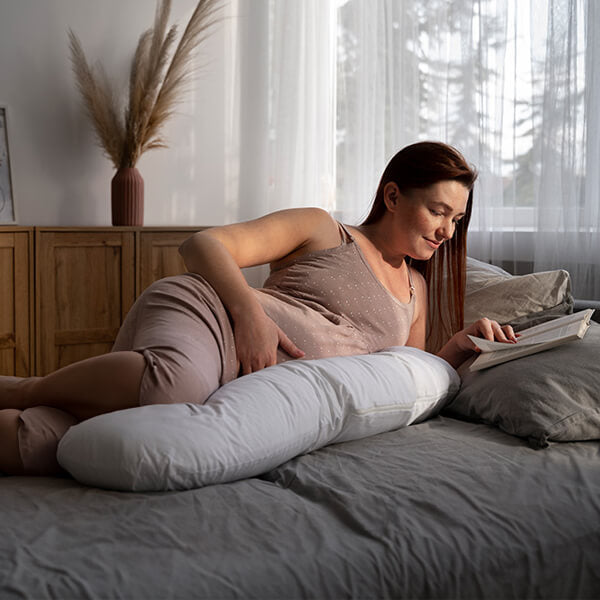 pregnant woman sleeping happy on best hybrid mattress with superior support