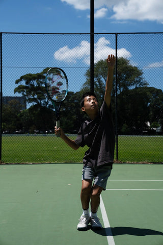 Men's tennis socks. Tennis player serving in trophy position.