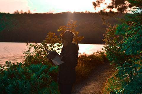 girl reading map on trail