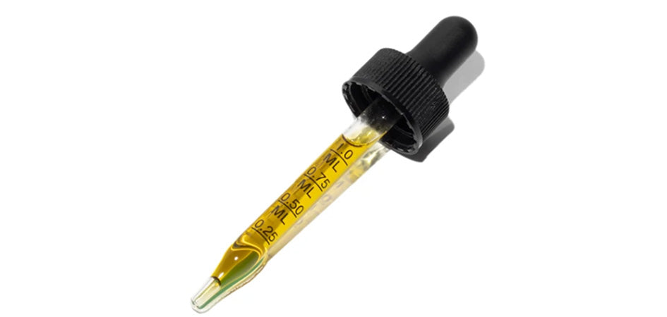 Dropper full of CBD hemp oil for pain.