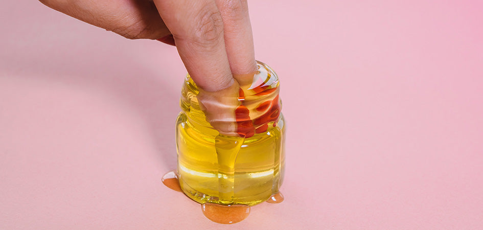 Fingers in small jar of hemp oil. Where can i buy hemp oil? buy cbd online