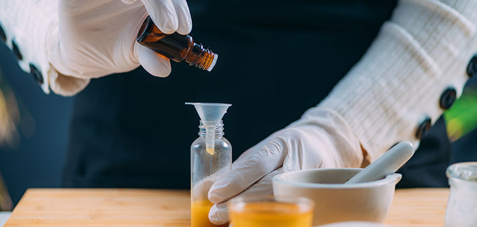 Pouring CBD oil in a bottle in a lab. buy cbd oil online.