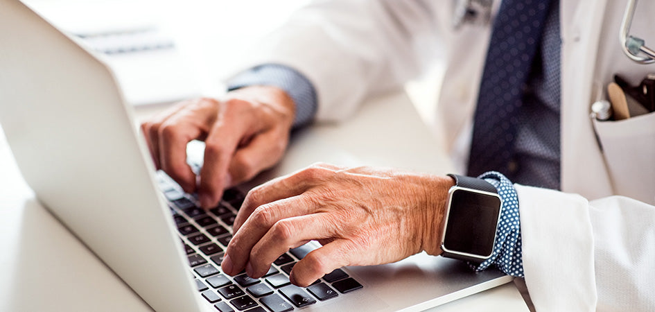 Medical doctor typing on laptop. How do you use cbd oil? best time of day to take cbd oil. when to take cbd oil for sleep. best way to take cbd oil.