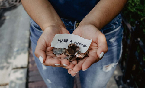 Make A Change - Woman holding coins