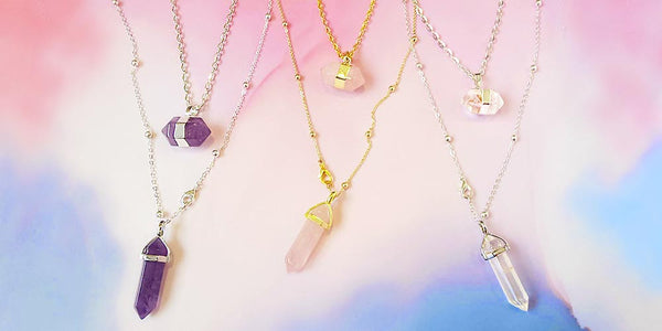 Chakra necklaces stone jewellery in purple, pink and crystal on purple pink background