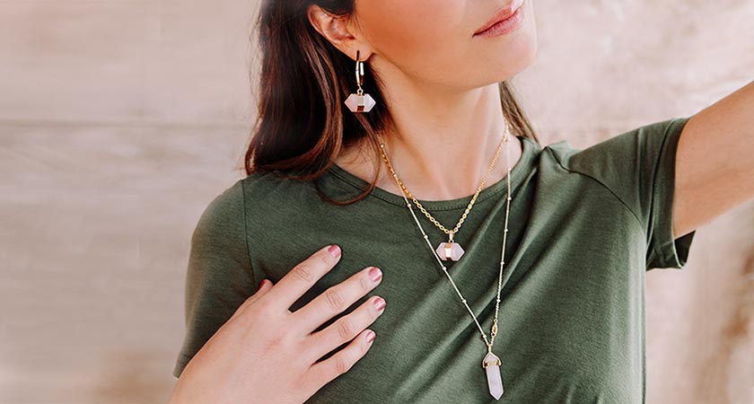 Chakra rose quartz earrings and layered necklace on model