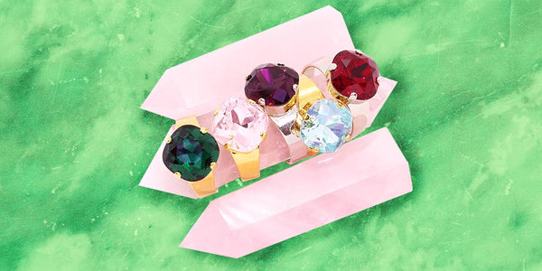 Zodiac birthstone rings Christmas gifts for her on pink crystal stone with green background