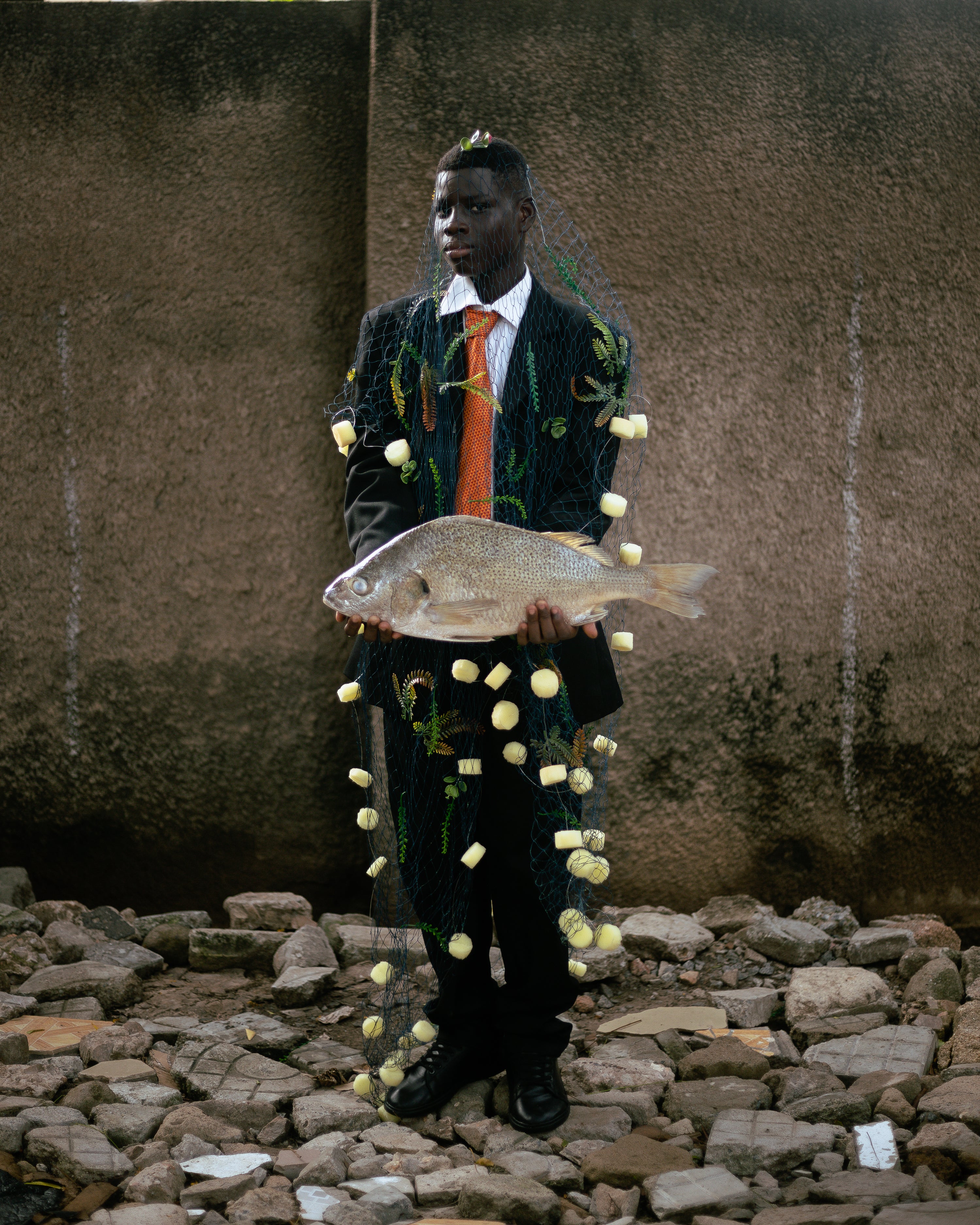 Editorial fashion photography against a stone wall holding a light colour  handbag at an angle.jpg, Home of Studióski