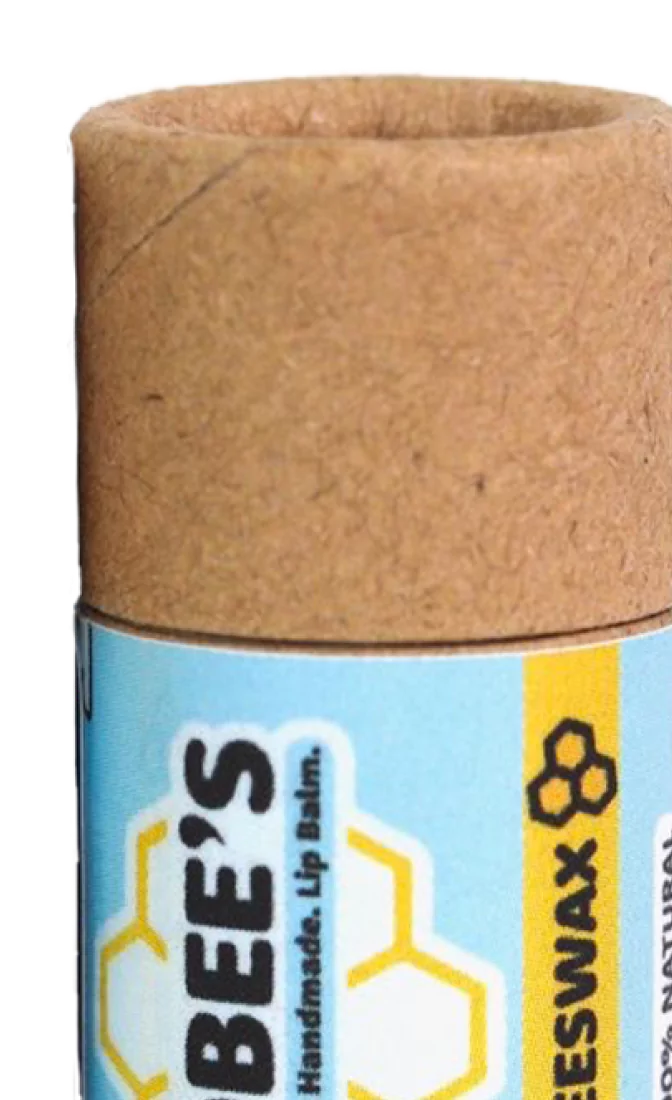 Cardboard tube of beeswax lip balm with blue and yellow label.