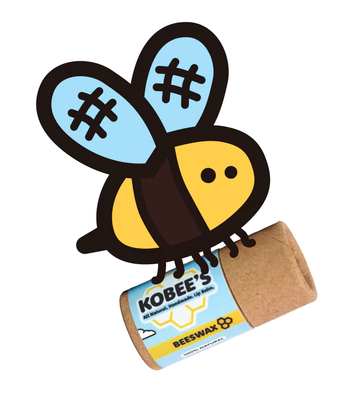 Cartoon bee next to a tube of Kobee’s All Natural Beeswax Lip Balm.