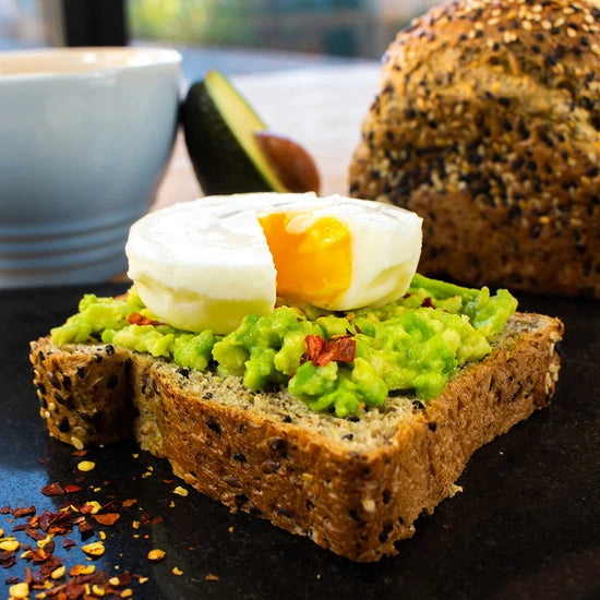 Low carb bread topped with smashed avocado and a poached egg. 