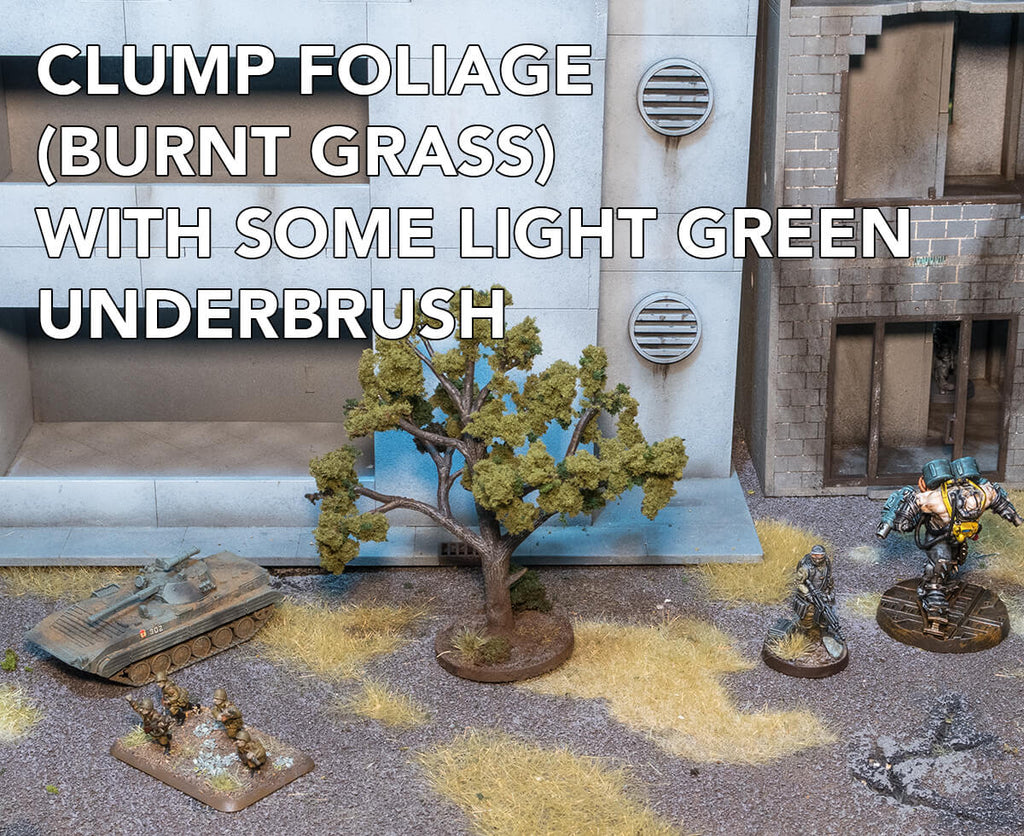 Woodland Scenics Clump Foliage (burnt Grass) with light green underbrush applied. Terrain and miniatures are shown for scale. 