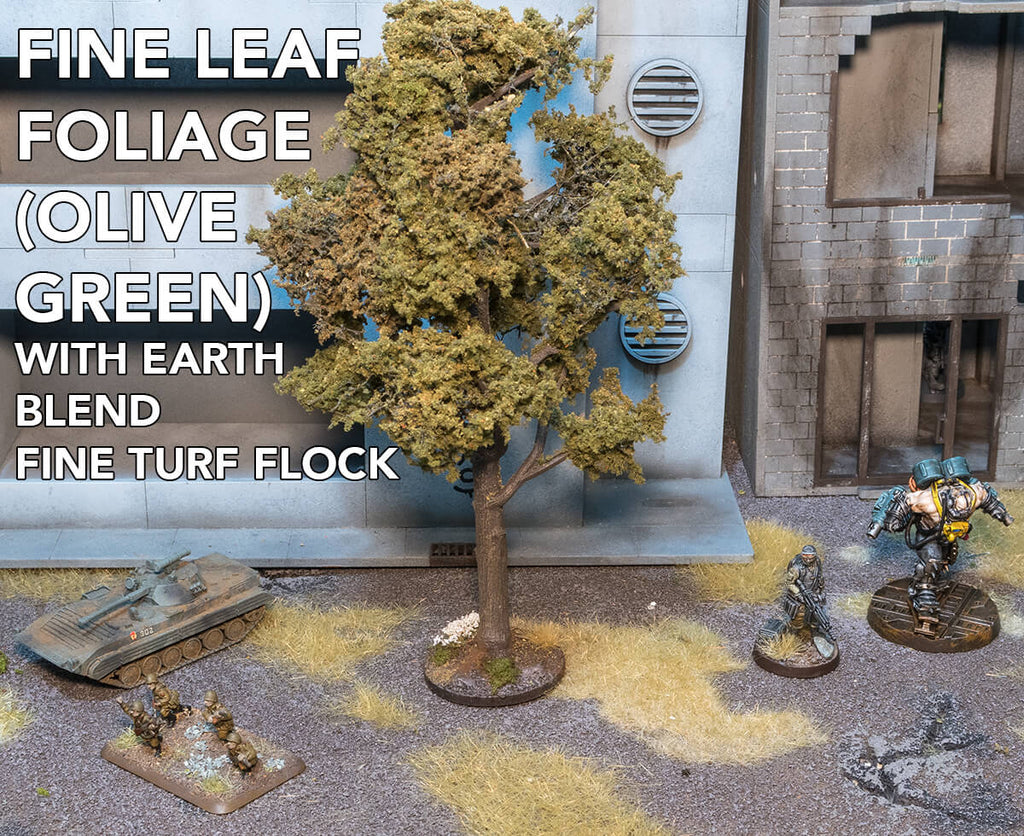 Woodland Scenics Fine Leaf Foliage with Earth Blend Fine Turf Flock. The foliage has been applied to a tree armature. Miniatures and Terrain are shown for scale.