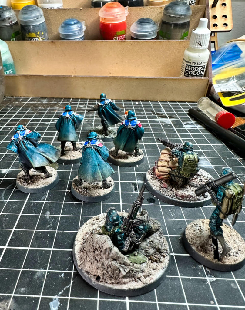 Infinity french sci-fi miniatures painted blue with MDF paintrack in background