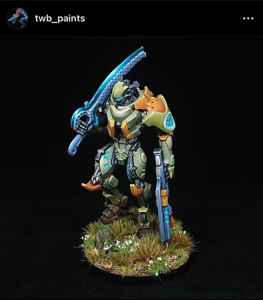 Infinity tikbalang TAG mech miniature - Mech standing with a green, blue and orange colour scheme.