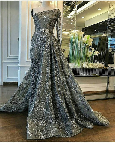 A custom gray gown with long sleeves and a train, perfect for a formal occasion.