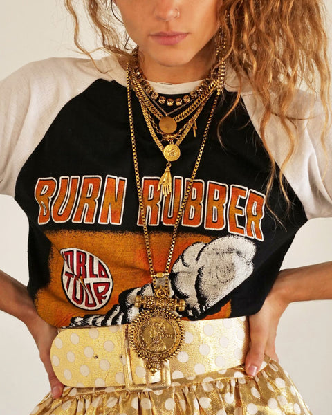 Woman in vintage t-shirt, gold pants and gold DYLAN LEX jewelry