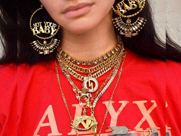 Woman in red t-shirt wearing gold  DYLAN LEX necklaces and earrings