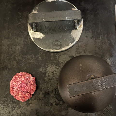 meat ball, burger press and Cloche on an Axel Perkins Plancha