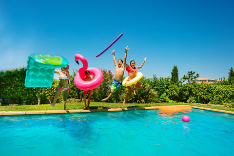 people jumping into inground swimming pool