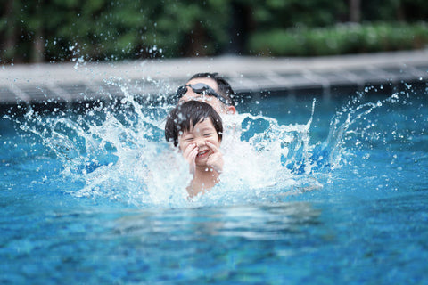 child swimming in pool