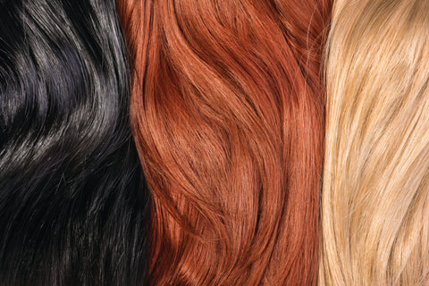 dark brunette, red, and blonde hair side-by-side to show variance in color 